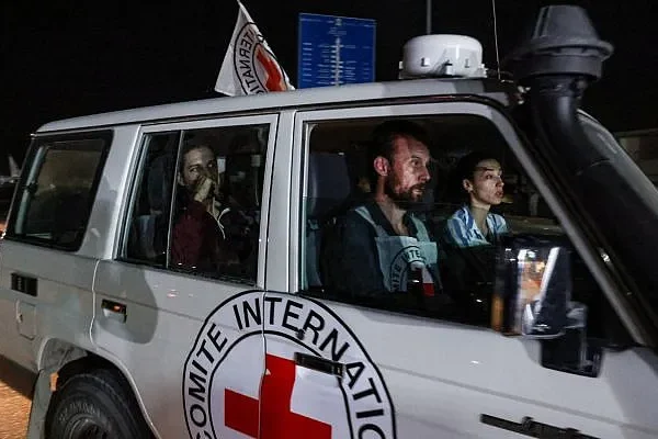 Illustrative: An International Red Cross vehicle carrying Israeli Russian hostage Ron Krivoy released by Hamas drives towards the Rafah border point with Egypt ahead of a transfer to Israel on November 26, 2023. (Mohammed ABED / AFP)