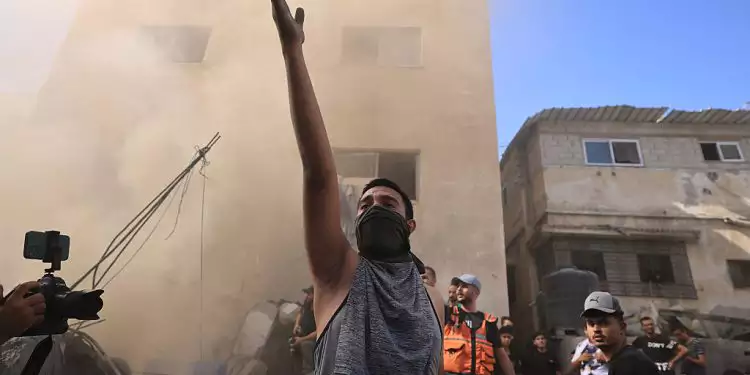 A Palestinian man reacts as others check the rubble of a building in Khan Yunis on November 6, 2023 Photo AFPMahmud Hams