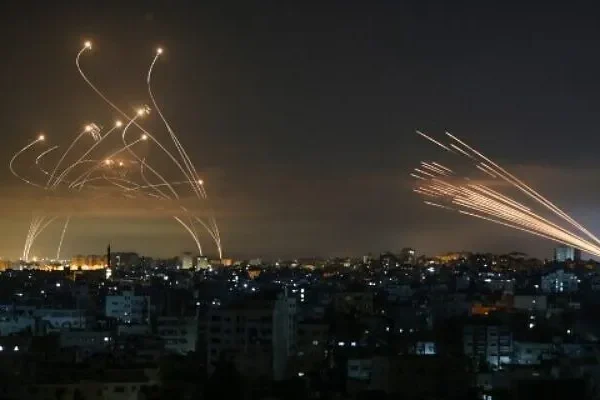 Iron Dome (left) intercepts rockets fired by Hamas from Gaza (right) on May 14, 2021.Anas getty imges