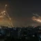 Iron Dome (left) intercepts rockets fired by Hamas from Gaza (right) on May 14, 2021.Anas getty imges
