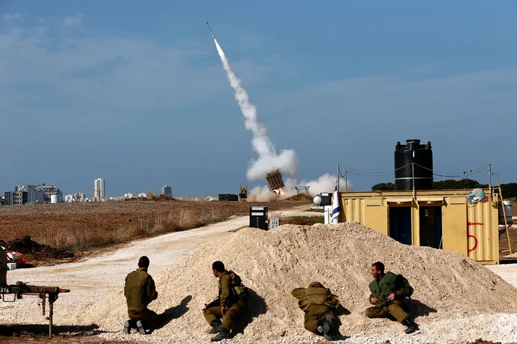 Israeli soldiers, above, this month watched the launch of an Iron Dome antimissile weapon designed to blast Hamas rockets out of the air. (REUTERS)