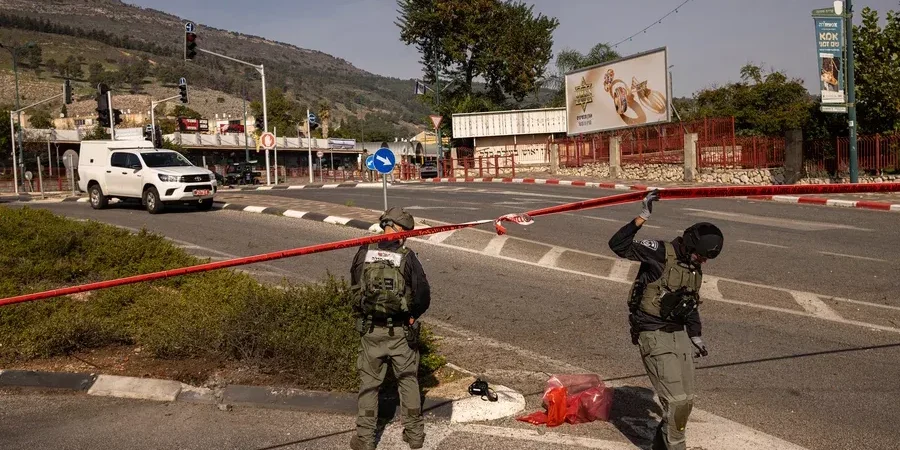 Israeli police inspect the area where an anti-tank missile fired from Lebanon landed in Kiryat Shmona, Israel