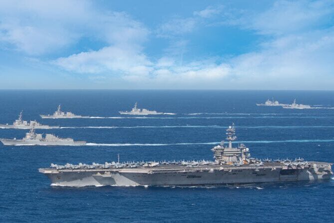 The USS Theodore Roosevelt carrier strike group transits in formation (US Navy),jpeg