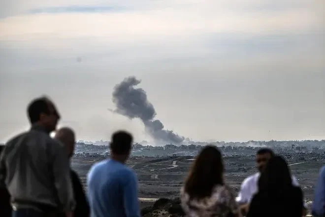 People in Sderot, Israel, watch smoke rise over Gaza after Israeli attacks on January 14, 2025.Mostafa Alkharouf via Getty Images