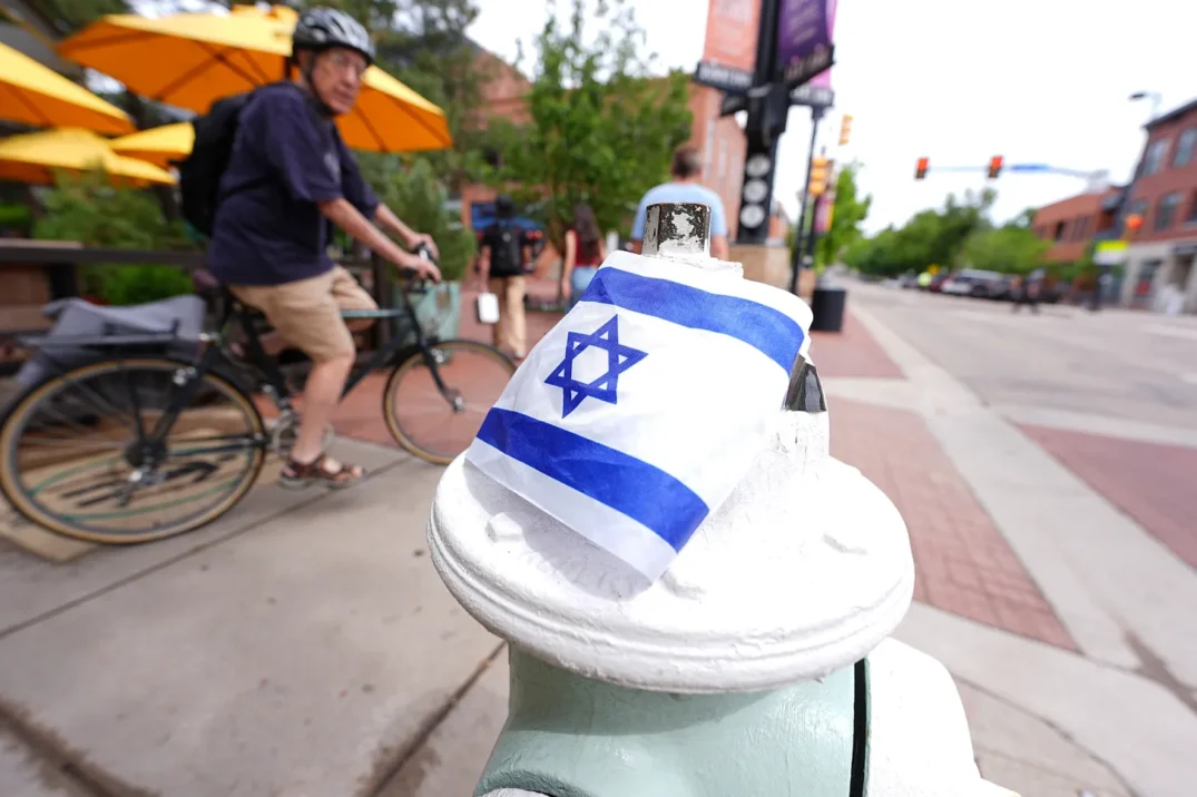 Cyclist passes by the flag of Israel AP Photo David Zalubowski Cyclist passes by the flag of Israel AP Photo David Zalubowski