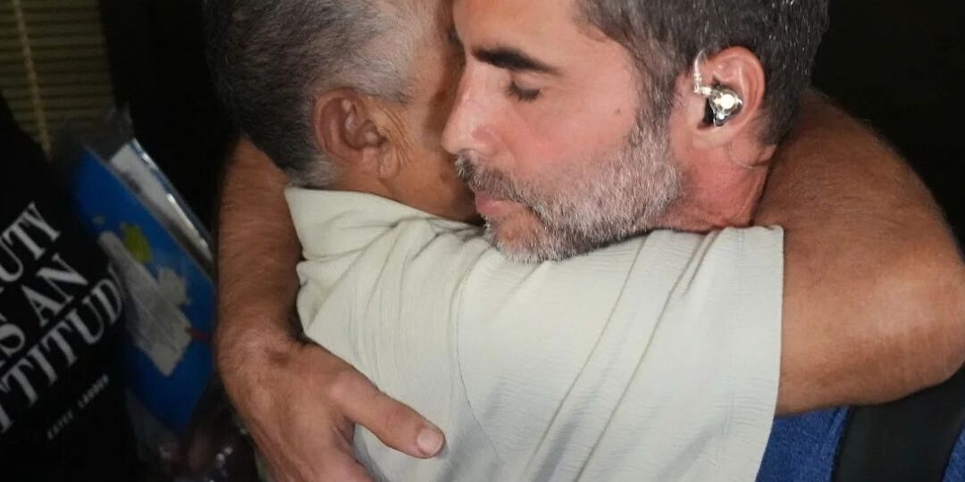 Israeli passenger of flydubai Flight FZ1073 hugs another passenger at Ben Gurion Airport